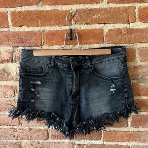 Distressed black jean shorts, size M